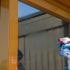 Spraying cleaning solution onto glass
