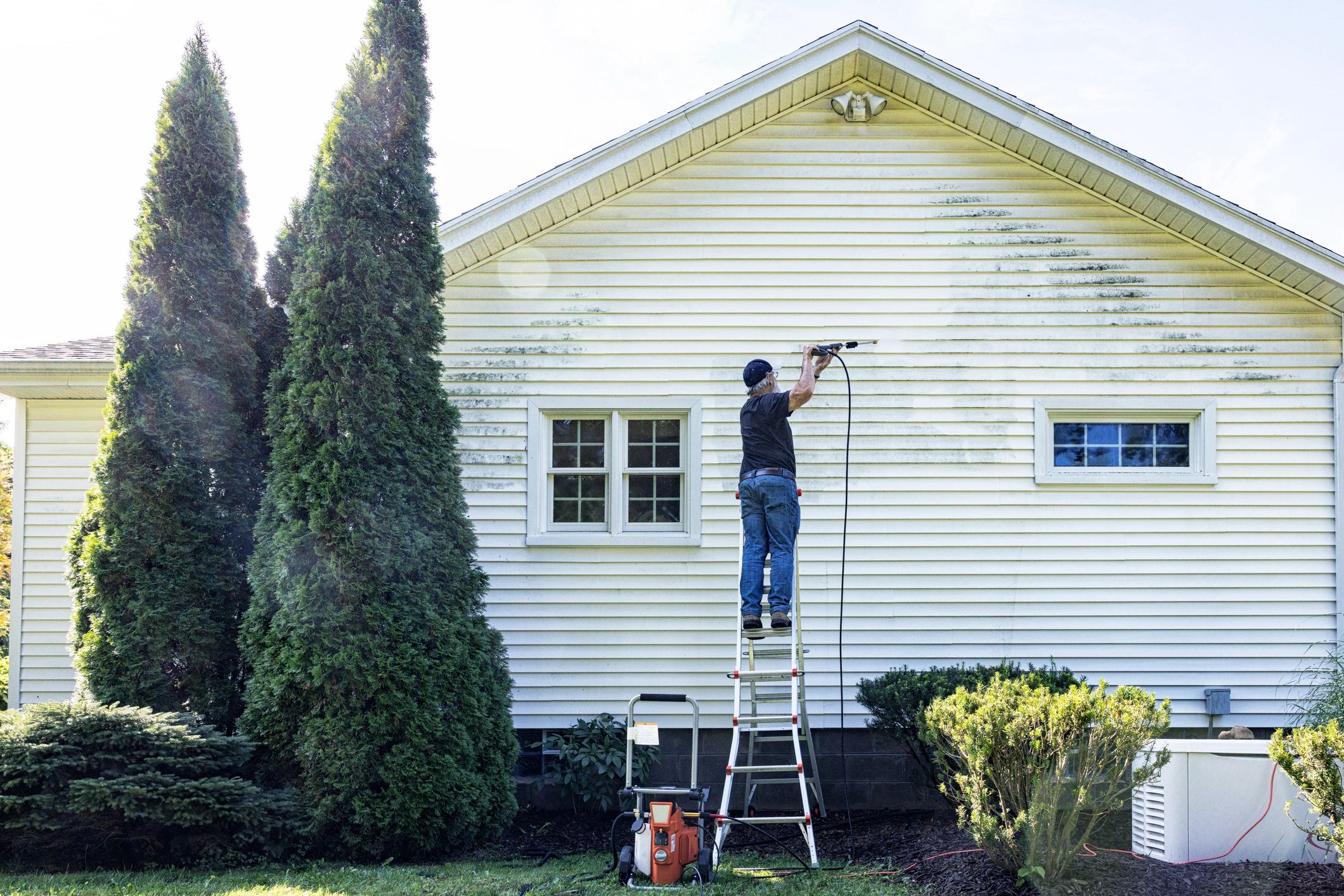 Window cleaning technician on ladder