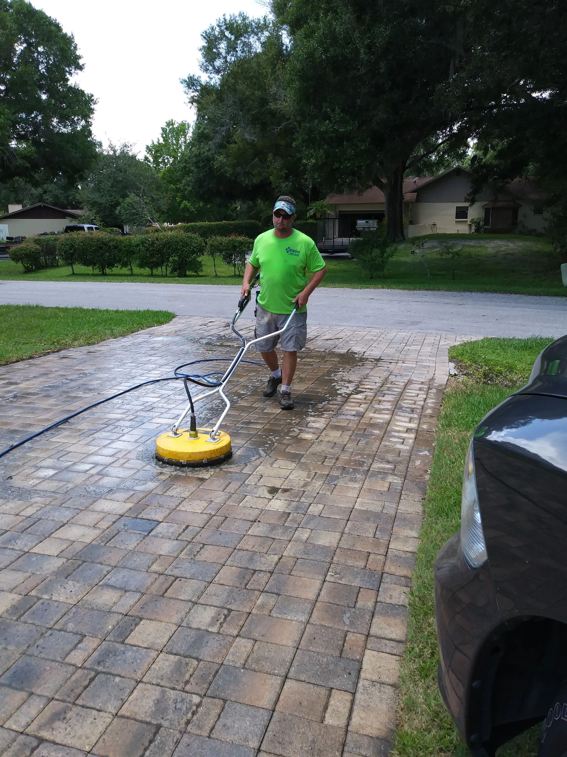 Pressure washing driveway and building exterior in Tampa Bay Florida